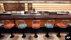 FILE - The lunch counter at the former F.W. Woolworth is shown at the International Civil Rights Center and Museum in Greensboro, N.C., Jan. 7, 2010.