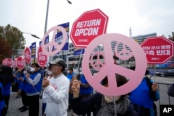 Protesters stage a rally to demand peace on the Korean peninsula in front of the presidential office in Seoul, South Korea, Nov. 3, 2022.