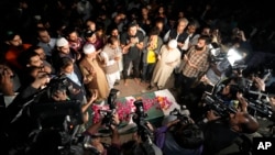 People attend the funeral of Sadaf Naeem, 36, a television journalist, in Lahore, Pakistan, Oct. 31, 2022. Naeem was crushed to death Sunday while covering a political march led by former Prime Minister Imran Khan.