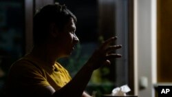 Yaroslav Vedmid talks with the Associated Press in a village during a blackout on the outskirts of Kyiv, Ukraine, Oct. 27, 2022. Since early October, Russian attacks on Ukraine's energy infrastructure have triggered power cuts across the country.