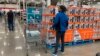 FILE - Shoppers wander the aisles of a Costco warehouse on Oct. 26, 2022, in Sheridan, Colo.