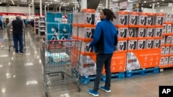 FILE - Shoppers wander the aisles of a Costco warehouse on Oct. 26, 2022, in Sheridan, Colo.