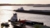 FILE - Barges make their way up the Mississippi River, where the water levels have reached record lows, in Memphis, Tennessee, Oct. 22, 2022. 