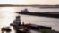 FILE - Barges make their way up the Mississippi River, where the water levels have reached record lows, in Memphis, Tennessee, Oct. 22, 2022. 