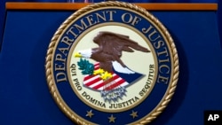 FILE - The Justice Department seal is seen in Washington, Nov. 28, 2018. A suspected participant in a ransomware scheme has been charged in the United States, the department said Nov. 10, 2022. Mikhail Vasiliev was arrested Wednesday.