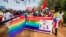 People holding rainbow flags take part in the Gay Pride parade in Entebbe, Aug. 8, 2015. 