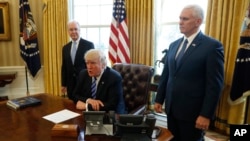 President Donald Trump, flanked by Health and Human Services Secretary Tom Price, left, and Vice President Mike Pence, meets with reporters regarding the health care overhaul bill at the White House in Washington, March 24, 2017.