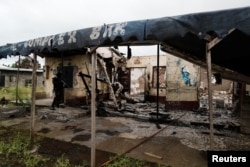 A Cameroonian elite Rapid Intervention Battalion (BIR) member patrols the abandoned village of Ekona near Buea in the anglophone southwest region, Oct. 4, 2018.