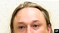 FILE - This undated file photo provided by The Ford County Sheriff's Office in Paxton, Ill., shows Michael Hari, a militia leader convicted of master­minding the bombing of a Minnesota mosque, Hari is now known by her transgender identity, Emily…