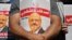 FILE - Friends of slain Saudi journalist Jamal Khashoggi hold posters bearing his picture as they attend an event marking the second anniversary of his assassination in front of Saudi Arabia's Istanbul consulate, Oct. 2, 2020. 