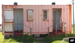 The rusty, dilapidated building that serves as a toilet for TB patients at a rural hospital in South Africa