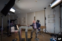 FILE - Dozhd Channel anchor Pavel Lobkov, prepares for a broadcast in their studio-apartment in Moscow, Russia, Dec. 10, 2014.