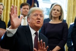 FILE - President Donald Trump speaks during a signing ceremony of the "Cybersecurity and Infrastructure Security Agency Act," in the Oval Office of the White House, Nov. 16, 2018, in Washington.