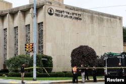 FILE - Police officers guard the Tree of Life synagogue following shooting at the synagogue in Pittsburgh, Penn., Oct. 27, 2018.