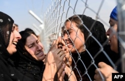 Newly displaced Iraqi's who fled from the city of Mosul, Iraq's last major so-called Islamic State (IS) group stronghold, are reunited with their relatives who came two years ago to the refugee camp in the Khazer area, near near the Kurdish checkpoint of Aksi Kalak, some 40 kilometres east of Arbil following their arrival on October 26, 2016.