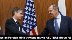 U.S. Secretary of State Antony Blinken greets Russian Foreign Minister Sergei Lavrov before their meeting, in Geneva, Switzerland, January 21, 2022. Russian Foreign Ministry/Handout via REUTERS