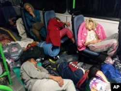 Migrants sit in a bus from Budapest to the Austrian border near Gyor, Hungary, Sept. 5, 2015.