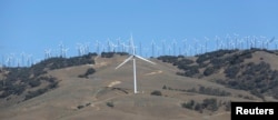 FILE - GE 1.6-100 wind turbines at a wind farm in Tehachapi, California, June 19, 2013.