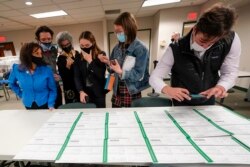 Democratic and Republican canvas observers inspect Lehigh County provisional ballots as vote counting in the general election continues, Friday, Nov. 6, 2020, in Allentown, Pa. (AP Photo/Mary Altaffer)
