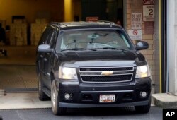 FILE - A vehicle believed to be carrying Mustafa al-Imam leaves U.S. District Court in Washington, Nov. 3, 2017.