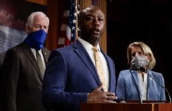 FILE - Senator Tim Scott (R-SC) is flanked by Senators Shelley Moore Capito (R-WV) and John Cornyn (R-TX) as he speaks about his new police reform bill unveiled by Senate Republicans during a news conference on Capitol Hill in Washington, June 17.