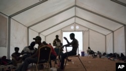 FILE - Sierra Leone migrants who were expelled from Algeria wait for repatriation in an International Organization for Migration center in Agadez, Niger, June 5, 2018.