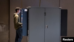 A young man votes in midterm elections at the Center for Civil and Human Rights in Atlanta, Georgia, November 8, 2022. 