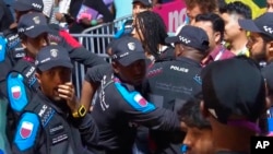 In this image from video, Qatari police try to control a crowd at a FIFA Fan Zone ahead of the World Cup in Doha, Qatar, Nov. 19, 2022.
