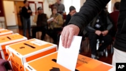 FILE - A vote is cast in Auckland, New Zealand, during a general election on Sept. 3, 2014.
