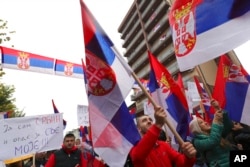 FILE - Kosovo Serbs wave Serbian flags during a protest in Mitrovica, Kosovo, Nov. 6, 2022. Several thousand ethnic Serbs rallied in Kosovo after a dispute over vehicle license plates.
