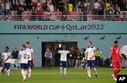 England's Bukayo Saka, center, celebrates after scoring his team's fourth goal during the World Cup group B soccer match between England and Iran at the Khalifa International Stadium in Doha, Qatar, Nov. 21, 2022.