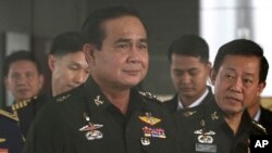FILE - Thailand's Army commander Gen. Prayuth Chan-Ocha, left, arrives at the Royal Thai Army Club in Bangkok, Thailand.