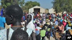 Women wait for grain to feed their families, at Doro refugee camp in South Sudan, December 2011.