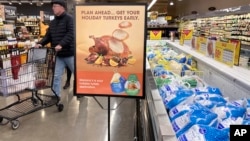 A man shops at a grocery store in Glenview, Illinois, Nov. 19, 2022. Americans are bracing for a costly Thanksgiving this year, with double-digit percent increases in the price of turkey, potatoes, stuffing, canned pumpkin and other staples. 
