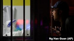 Seorang pria menjalani tes usap COVID-19 di salah satu lokasi tes di Beijing, pada 20 November 2022. (Foto: AP/Ng Han Guan)