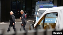 Police officers walk in front of Deutsche Bank headquarters in Frankfurt, Germany, Nov. 29, 2018.