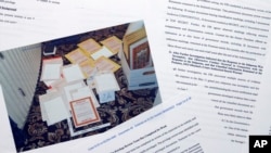 FILE - Pages from a Department of Justice court filing relating to the Aug. 8, 2022, search of former President Donald Trump’s Mar-a-Lago estate are photographed on Aug. 31, 2022. Included in the filing was an FBI photo of documents seized during the search.