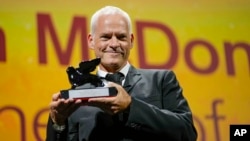 Director/writer Martin McDonagh holds the award for best screenplay for "The Banshees of Inisherin" at the 79th edition of the Venice Film Festival in Venice, Italy, Sept. 10, 2022.