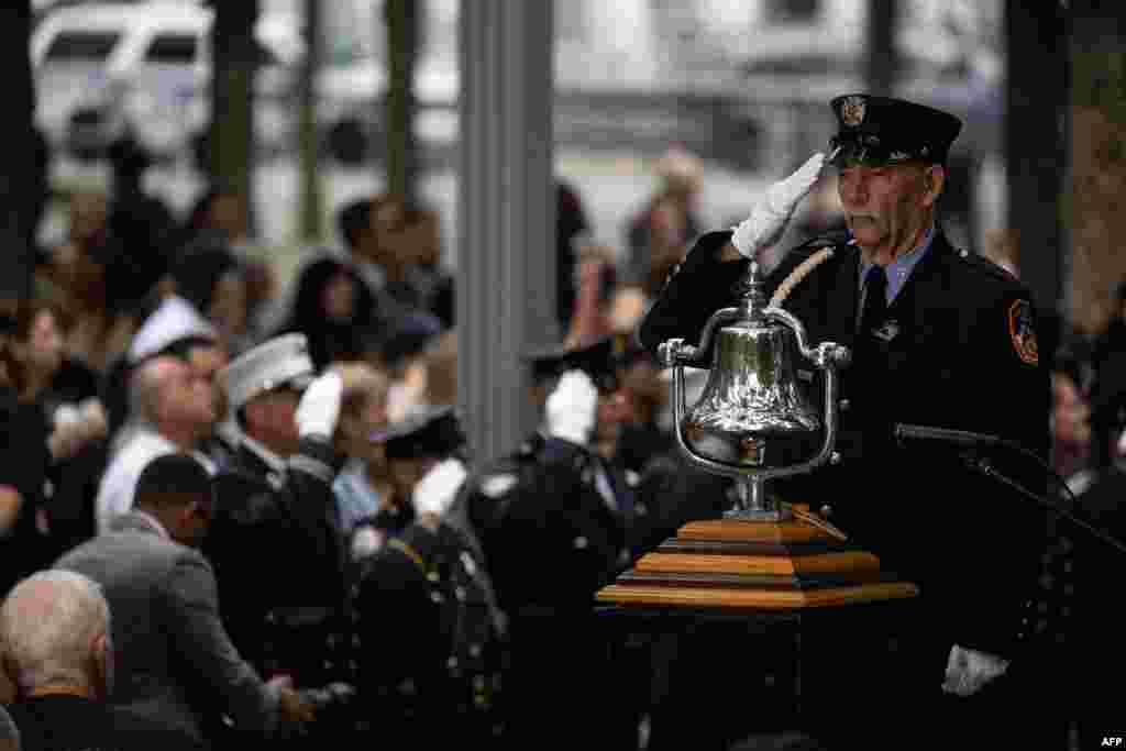 A member of the New York Fire Department salutes during a remembrance ceremony at the 9/11 Memorial in New York City, Sept. 11, 2022