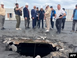 FILE - This handout photo taken on Sept. 1, 2022, shows the International Atomic Energy Agency team observing damage to the nuclear power plant in Enerhodar, Zaporizhzhia Oblast, Ukraine.