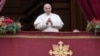 Pope Francis looks at the crowd before delivering the Urbi et Orbi (Latin for 'to the city and to the world' ) Christmas' day blessing from the main balcony of St. Peter's Basilica at the Vatican, Dec. 25, 2021.