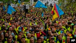 FILE - Truck drivers protest the high price of fuel in Madrid, Spain, on March 25, 2022. 