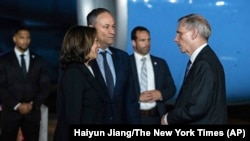 Vice President Kamala Harris, left, and her husband Doug Emhoff, center, are greeted by Robert Godec, U.S. Ambassador to Thailand, upon arrival at Don Mueang International Airport in Bangkok, Thailand, on Nov. 17, 2022, to attend the Asia-Pacific Economic Cooperation summit.