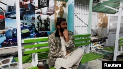 A Taliban fighter stands guard in an amusement park in Kabul, Afghanistan, Nov. 9, 2022. 