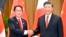 Japanese Prime Minister Fumio Kishida, left, and Chinese President Xi Jinping shake hands during their meeting on the sidelines of the Asia-Pacific Economic Cooperation forum, Nov. 17, 2022, in Bangkok.