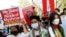 FILE - Myanmar citizens living in India attend a protest against the military coup in Myanmar and demanding recognition of the National Unity Government of Myanmar, in New Delhi, Feb. 22, 2022. 