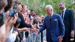 King Charles III greets members of the public outside Clarence House in London after he was formally proclaimed monarch by the Privy Council, Sept. 10, 2022. 