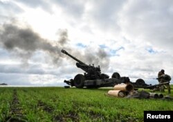 Ukrainian service members fire a shell from a towed howitzer FH-70 at a front line in the Zaporizhzhia Region, Ukraine Oct. 27, 2022.