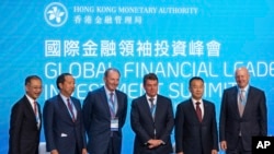 Leading participants of the Global Financial Leaders' Investment Summit pose for a photo, in Hong Kong, Nov. 2, 2022.