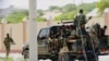 FILE - Somali soldiers are seen riding on a pick-up truck in Mogadishu, Somalia, April 27, 2022. 